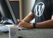 person in black and white t-shirt using computer