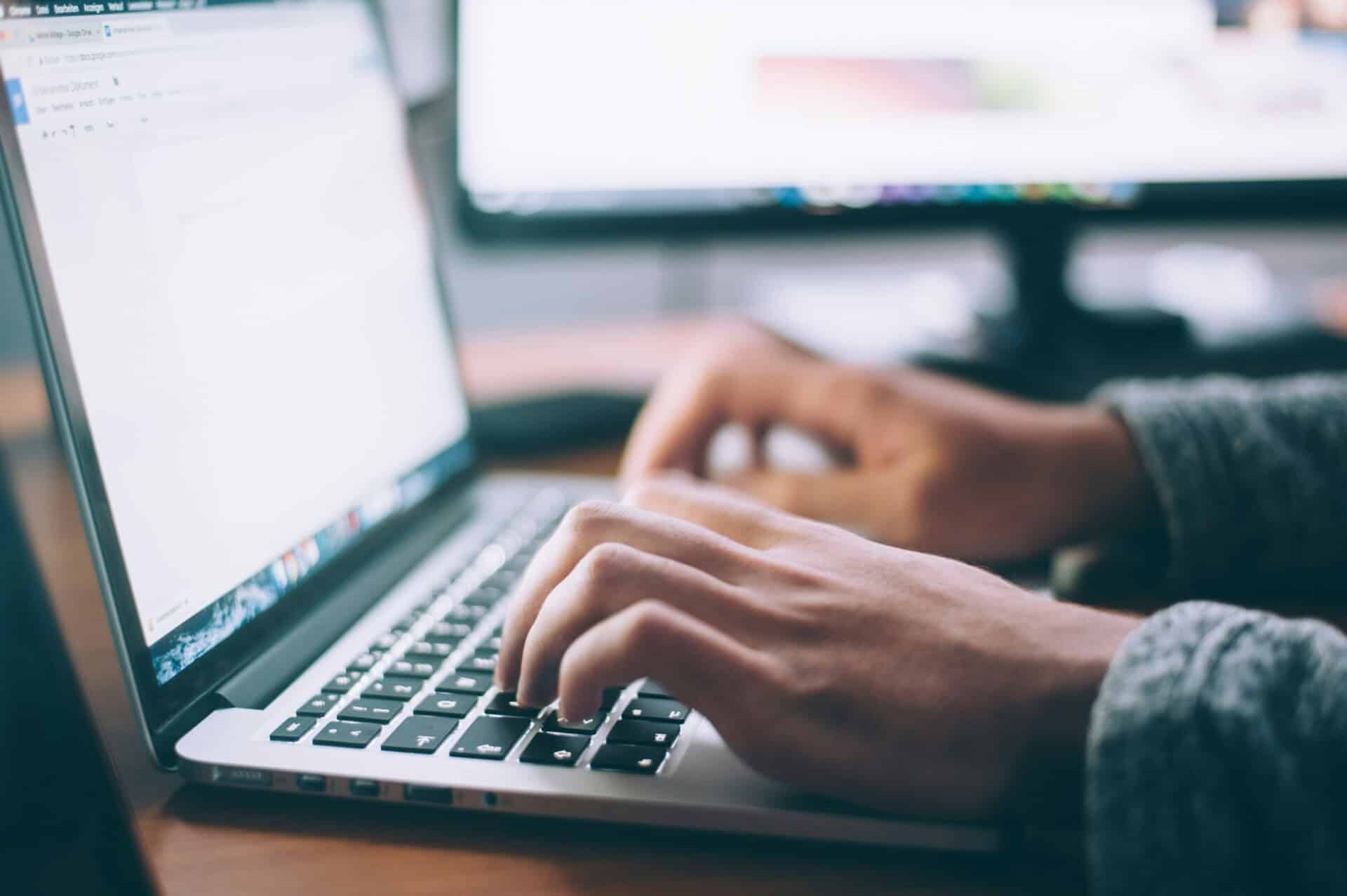 glenn-carstens-peters-npxXWgQ33ZQ-unsplash person using MacBook Pro